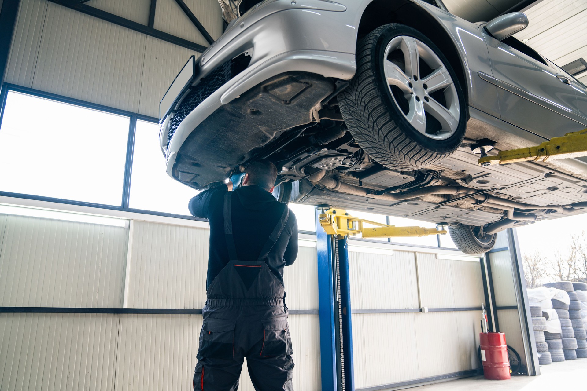 Car repair in car service. Car with opened car hood on a lift in a car service.